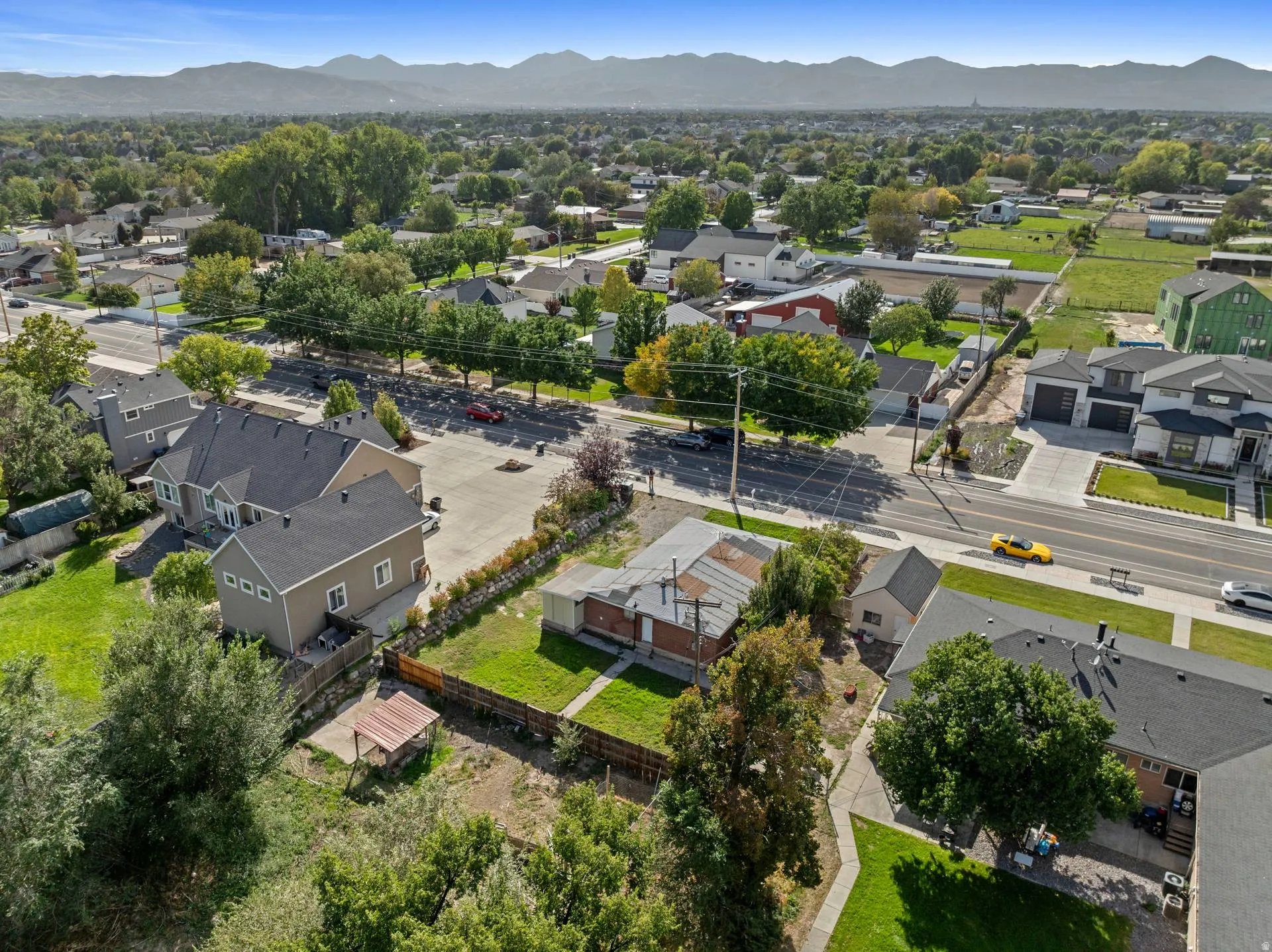 Established neighborhood setting with mature trees and mountain backdrop