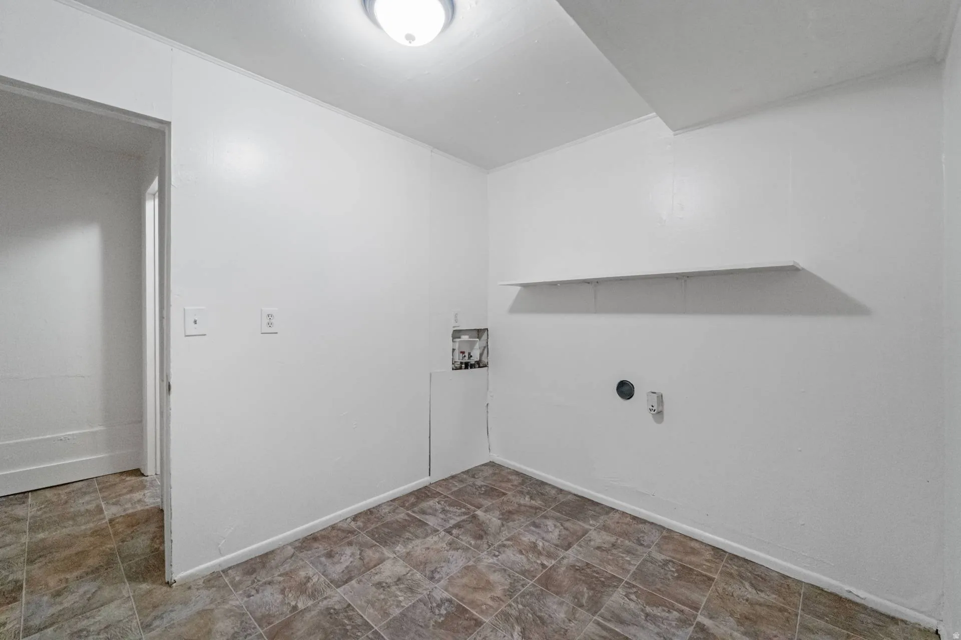 Recessed ceiling light fixture, wall-mounted shelving, and tile-finish flooring