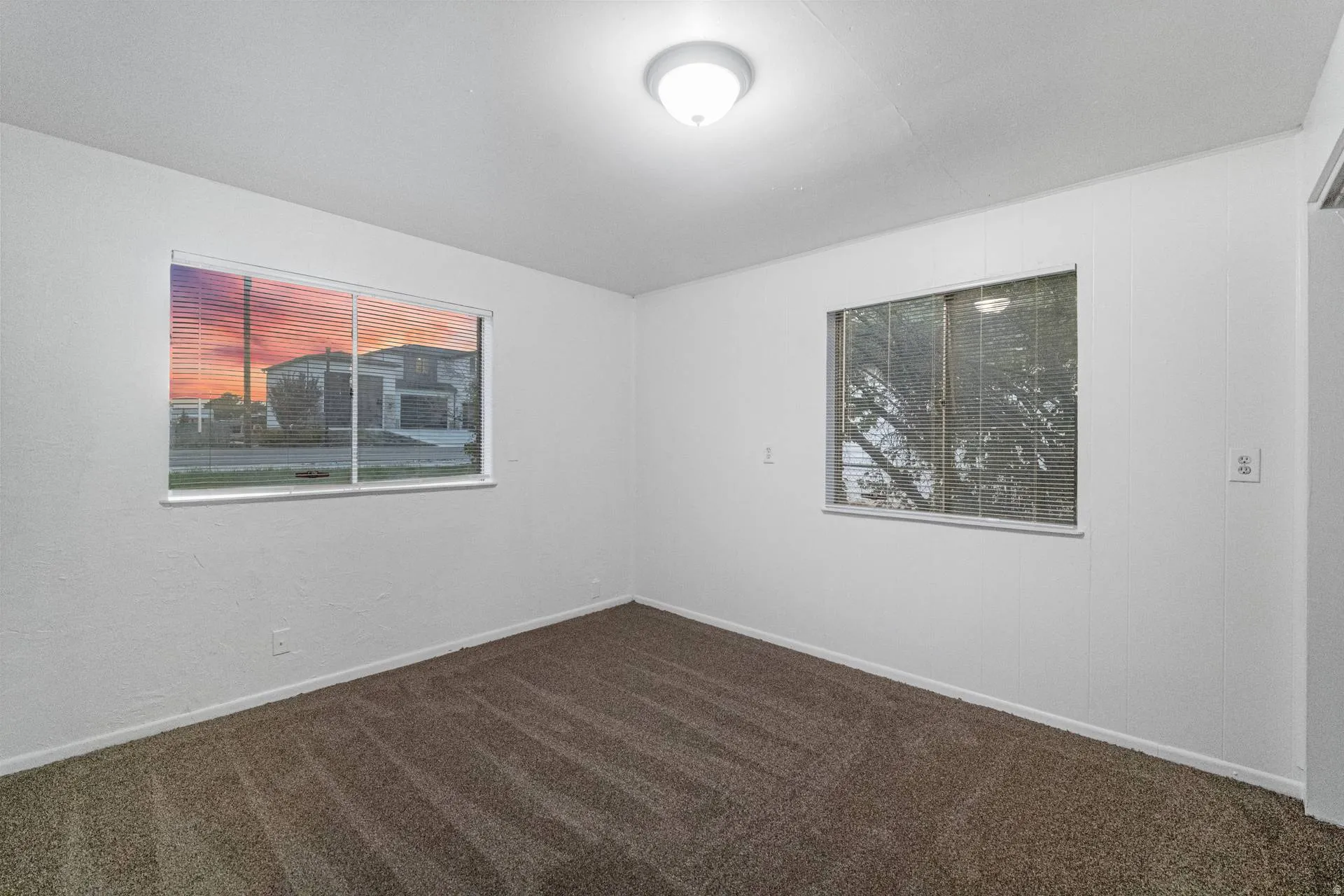 Neutral wall finishes, recessed lighting, and carpeted flooring