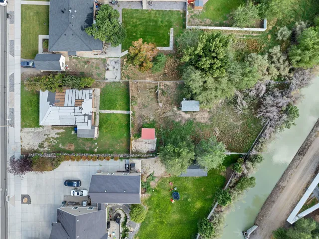 Property featuring multiple residences, a paved driveway, and a waterway border