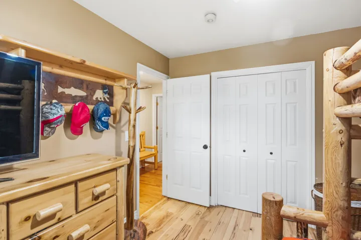 Wood-finish flooring with a panel-style bi-fold closet door