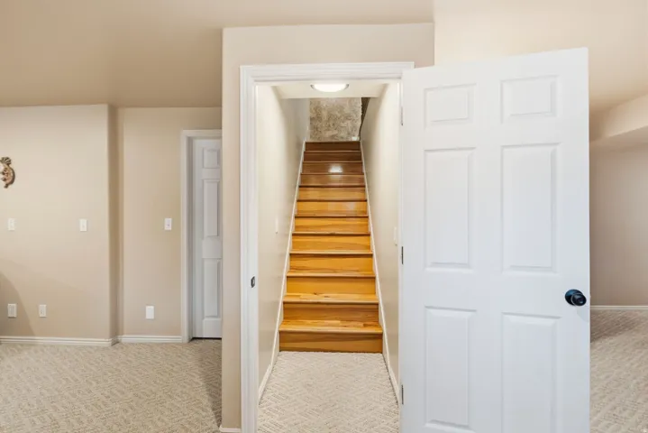 Hardwood staircase with overhead lighting