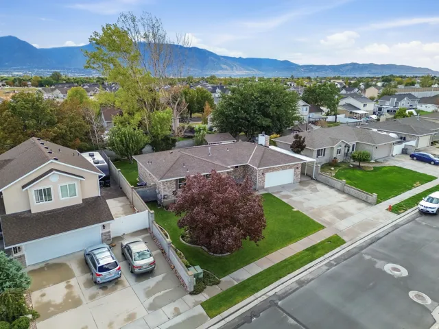 Contemporary two-story residence with an attached two-car garage, concrete driveway, and established front yard landscaping