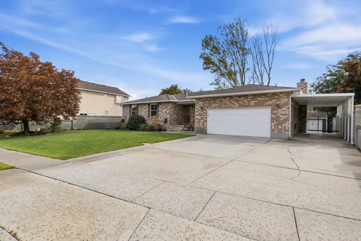 Brick exterior with a covered entryway and attached two-car garage
