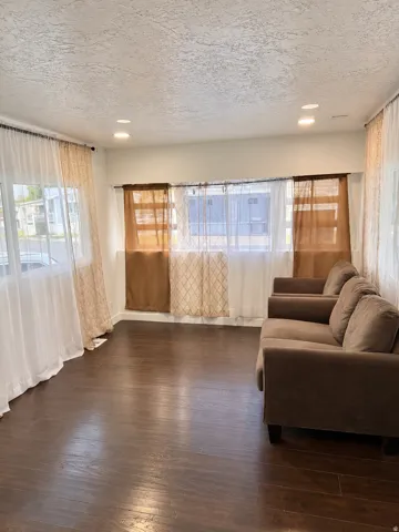 Recessed ceiling lighting, wood-finish flooring, and multiple window openings