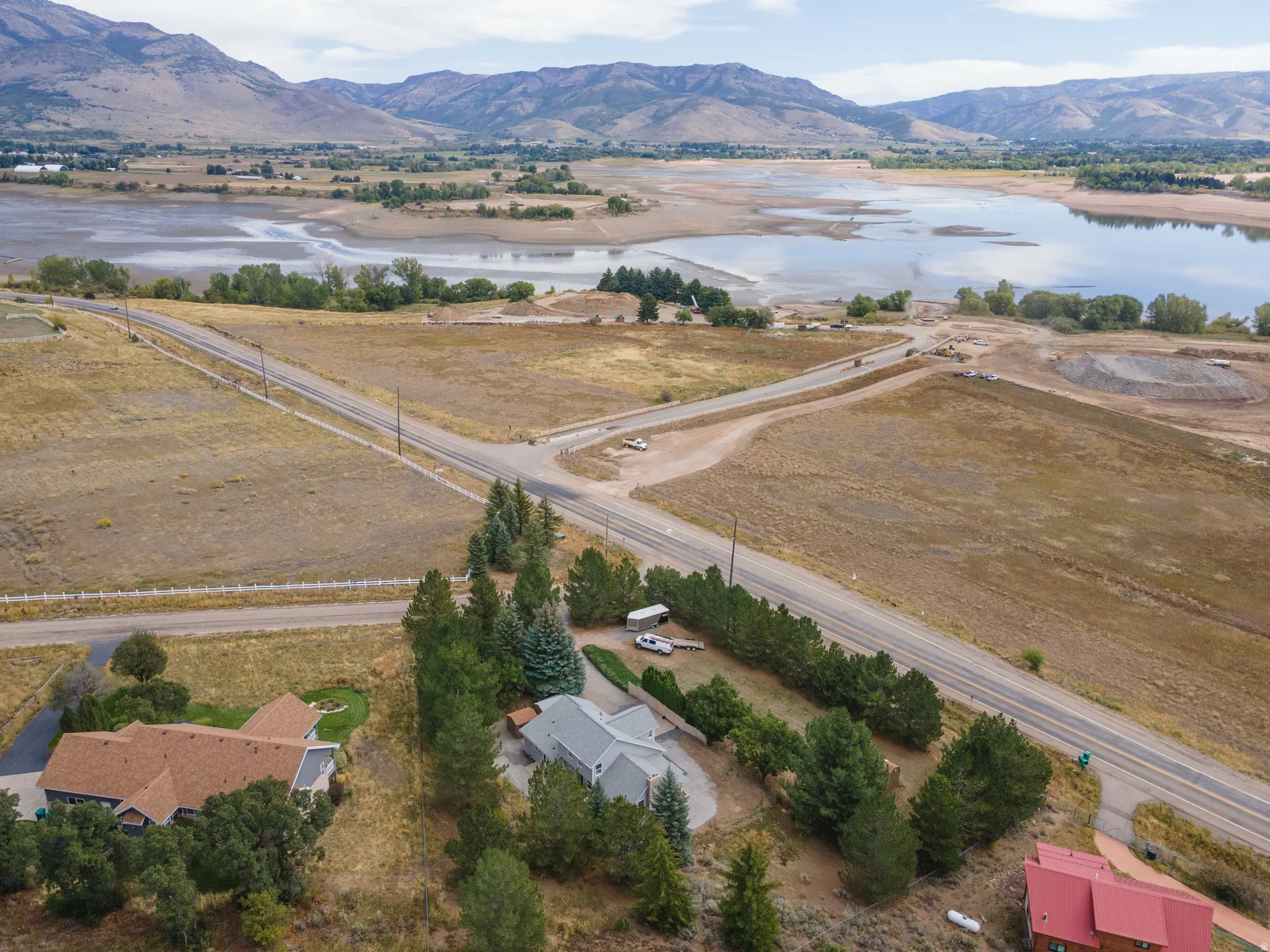 Expansive property featuring a paved road, natural land, and distant mountains