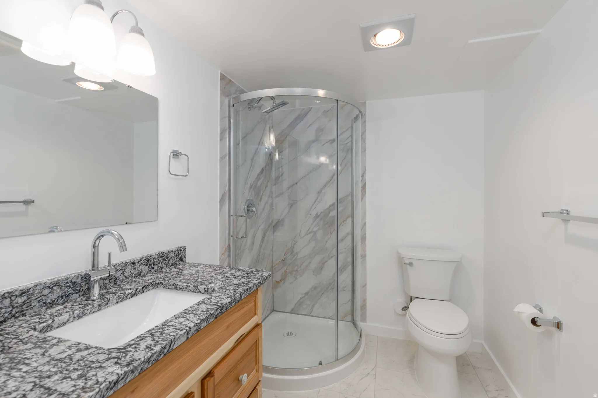 Vanity with granite countertop and undermount sink