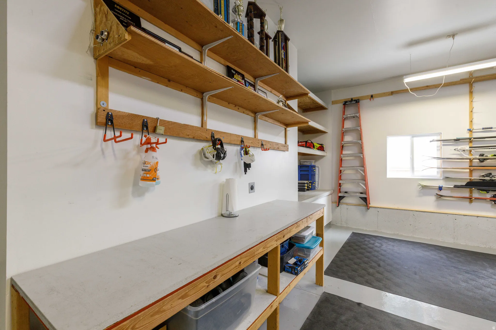 Integrated workbench, built-in shelving, organized wall storage, durable flooring