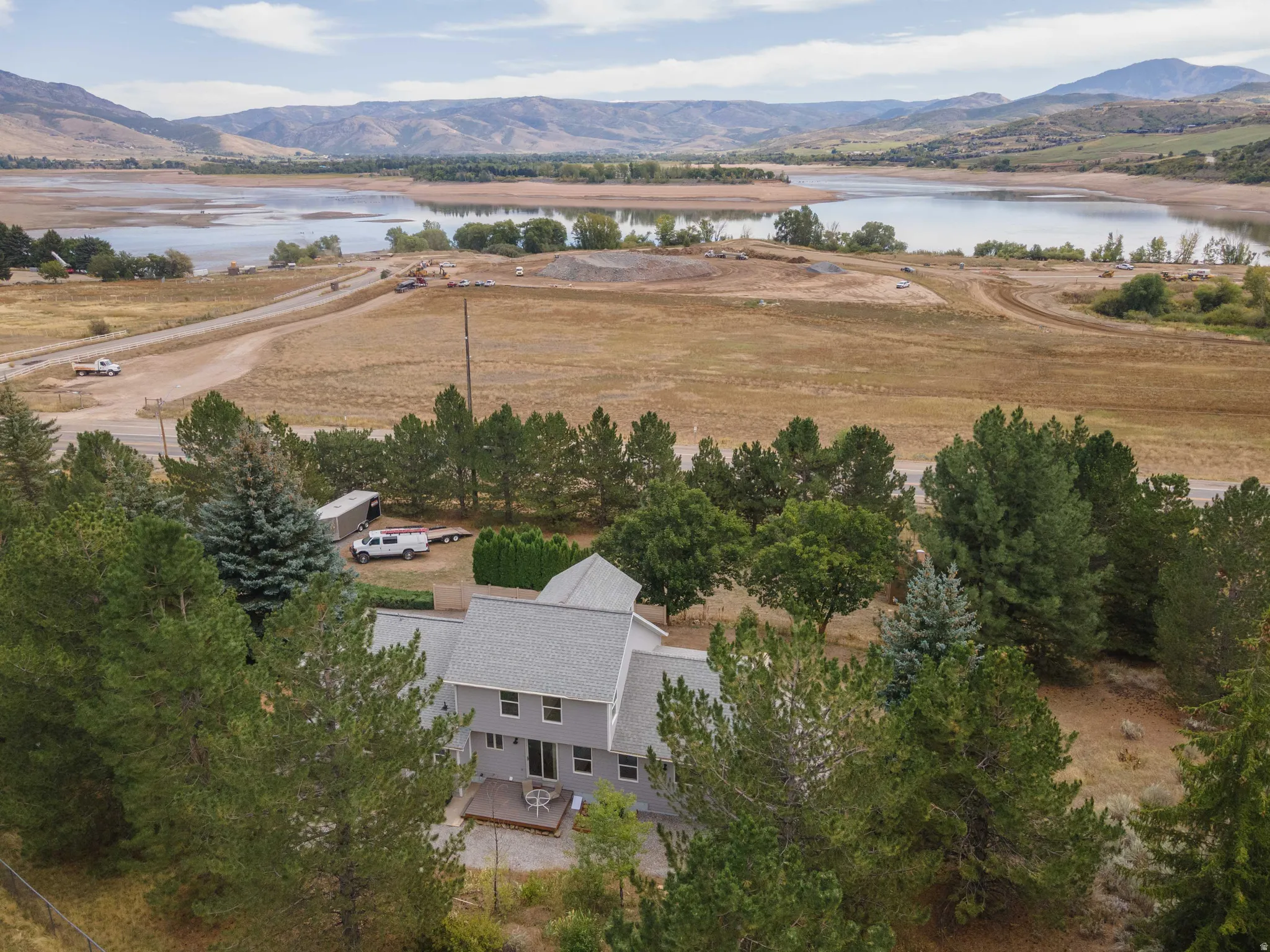 Expansive surrounding landscape featuring a large body of water and distant mountains