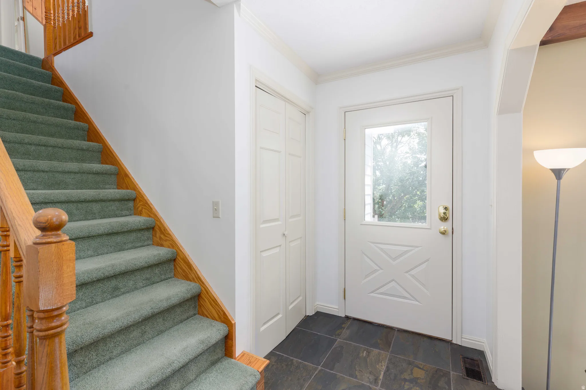 Wood staircase with carpeted treads