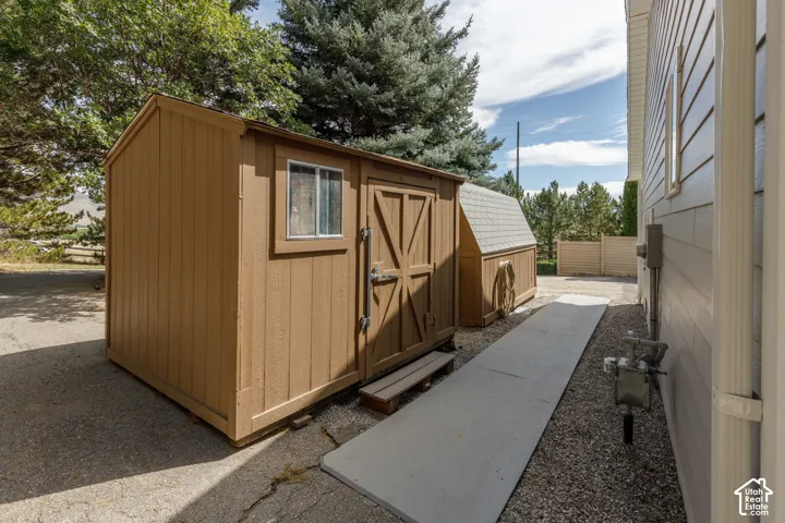 Freestanding shed with a window, dual doors, and a secondary smaller shed