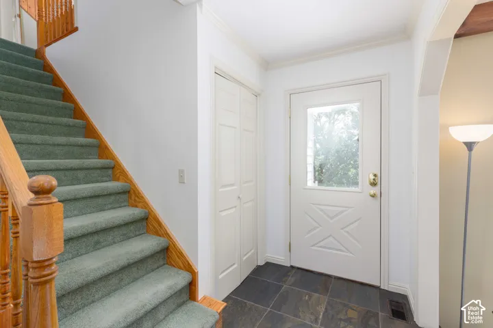 Wood staircase with carpeted treads