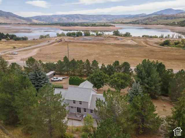 Expansive surrounding landscape featuring a large body of water and distant mountains