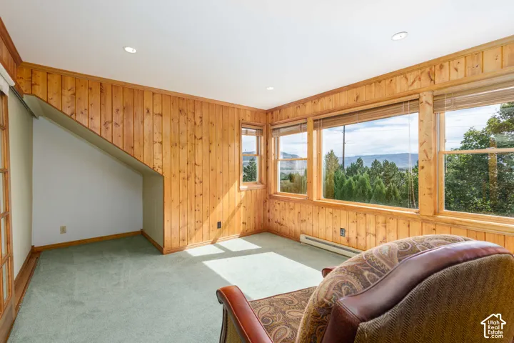 Pine wood paneled walls, recessed lighting, and expansive windows