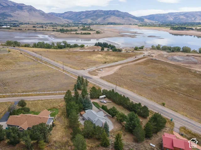 Expansive property featuring a paved road, natural land, and distant mountains