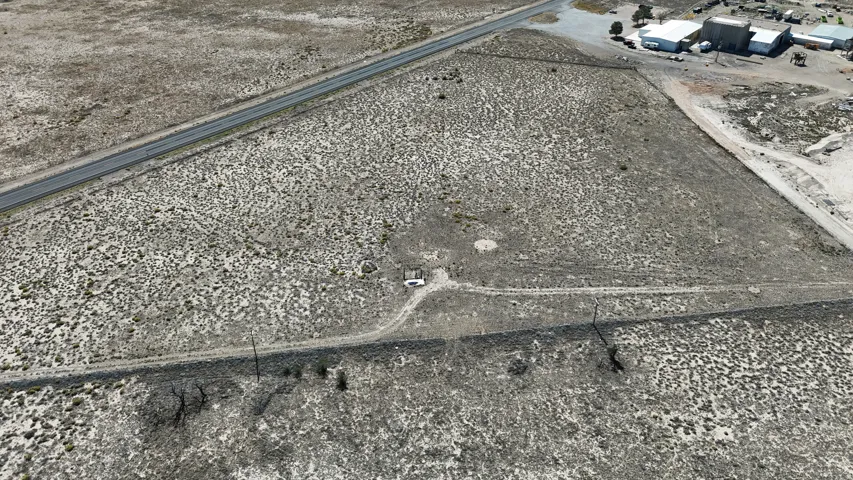 Expansive undeveloped land featuring natural terrain and direct road frontage