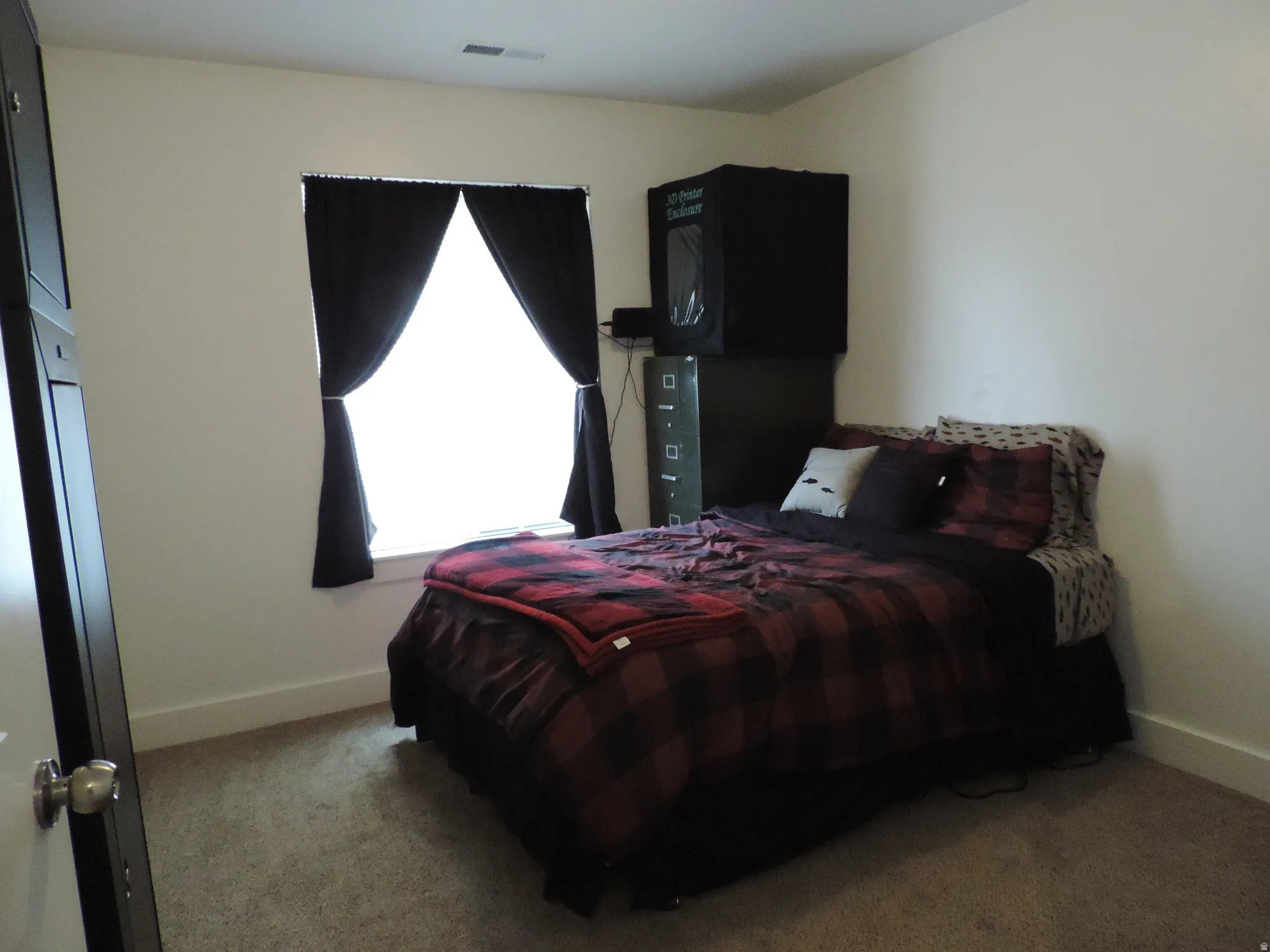 Carpeted flooring with light-toned wall finishes and a window