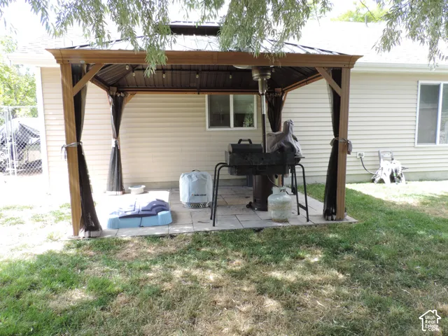 Freestanding patio gazebo with wood-look posts and a metal roof