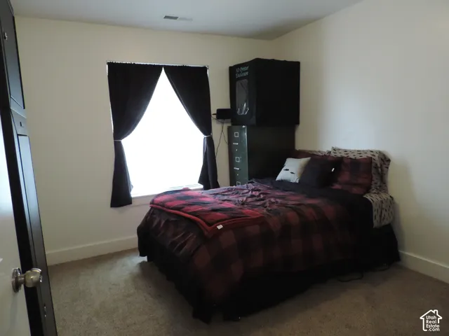 Carpeted flooring with light-toned wall finishes and a window