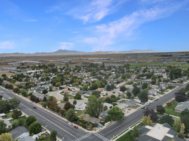 Established neighborhood setting with mature trees and paved roads