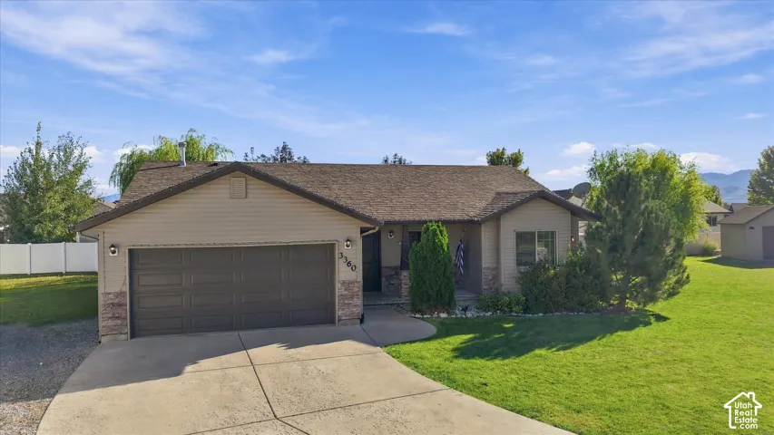 Ranch-style exterior with a two-car garage and a concrete driveway