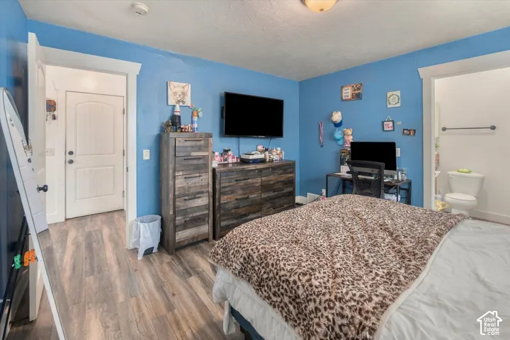 Wood-finish flooring throughout, white trim, and a built-in light fixture