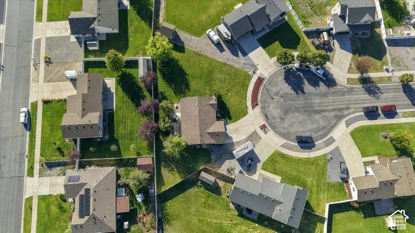 Residential cul-de-sac featuring paved roads and landscaped islands