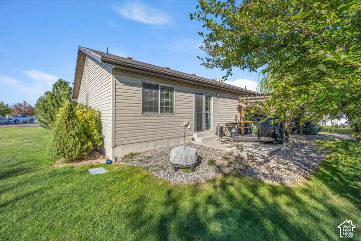 Exterior siding with a window, sliding glass door, and a concrete patio