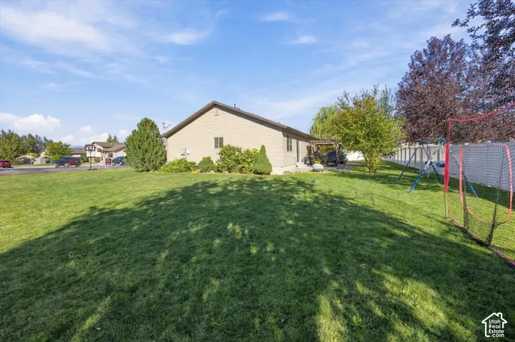 Expansive lawn area with mature trees and perimeter fencing