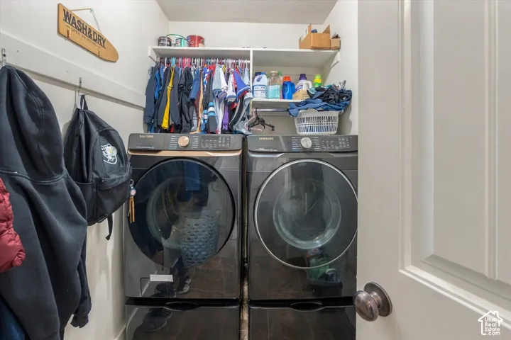 Built-in shelving and hanging rods above front-loading washer and dryer units