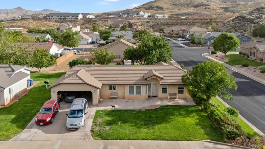 Single-story residence with a tiled roof, attached garage, and a concrete driveway