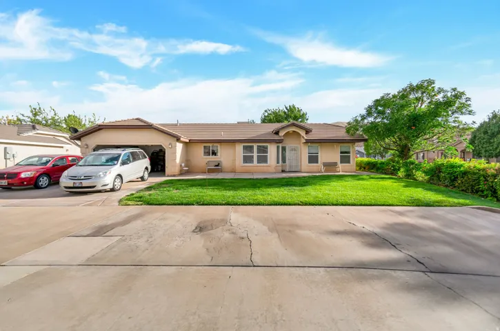 Single-story residence featuring a stucco exterior, attached garage, and a concrete driveway