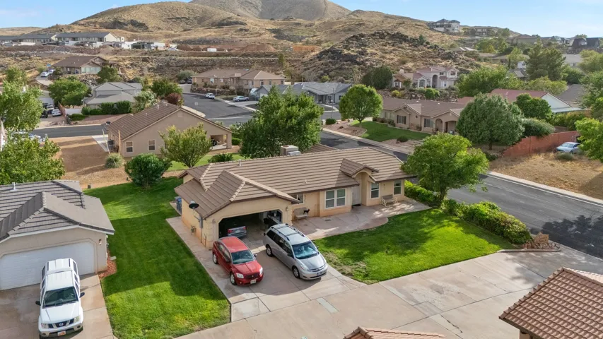 Single-story residence with a two-car garage, front lawn, and paved driveway