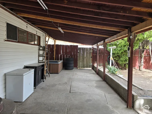 Covered concrete patio with exposed wood beam ceiling