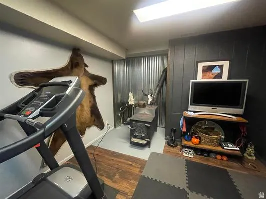 Wood-finish flooring, wood-burning stove, and ceiling-mounted lighting
