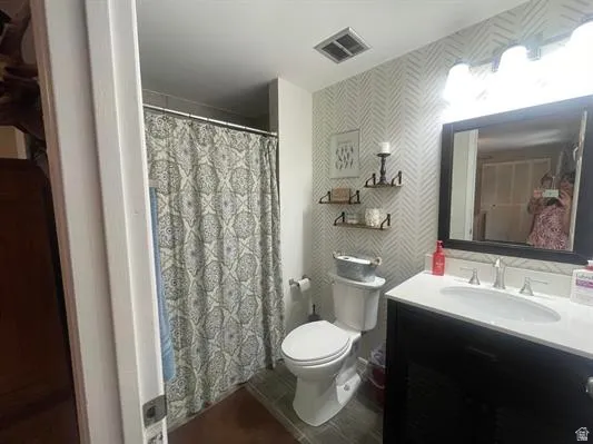 Black vanity with a white countertop and rectangular undermount sink