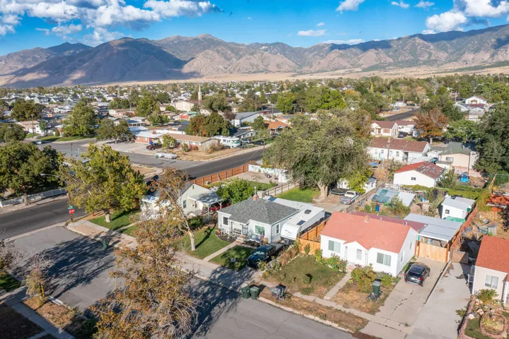 Residential neighborhood with mature trees and mountain backdrop