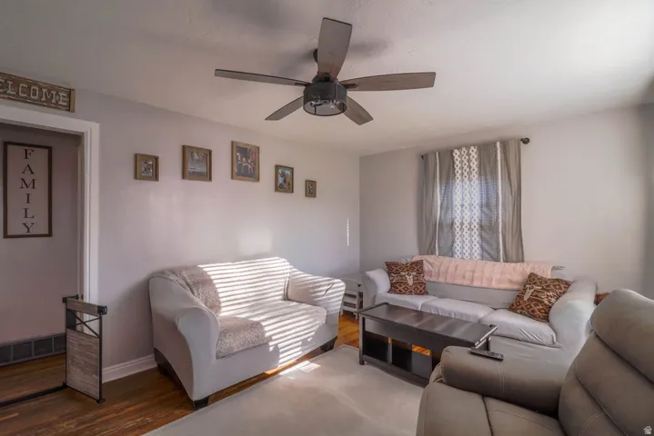 Wood-finish flooring with a light-toned area rug