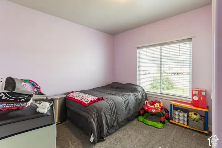 Soft purple walls complement the neutral gray carpeting