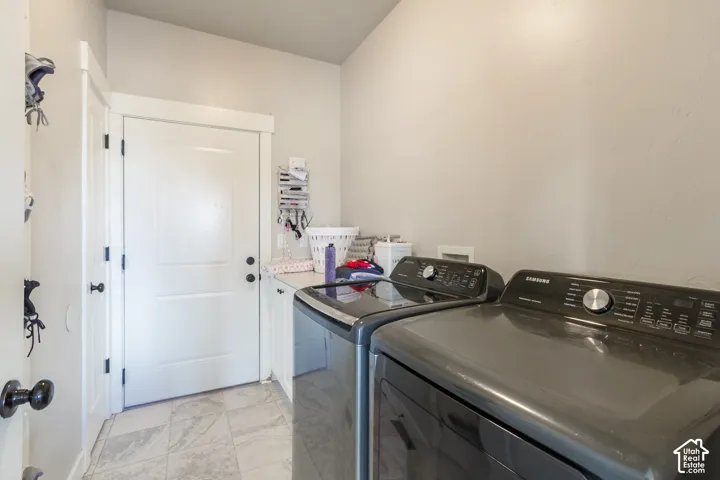 Tile flooring, white cabinetry, light-toned walls, and a solid white door