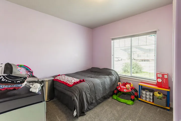Soft purple walls complement the neutral gray carpeting