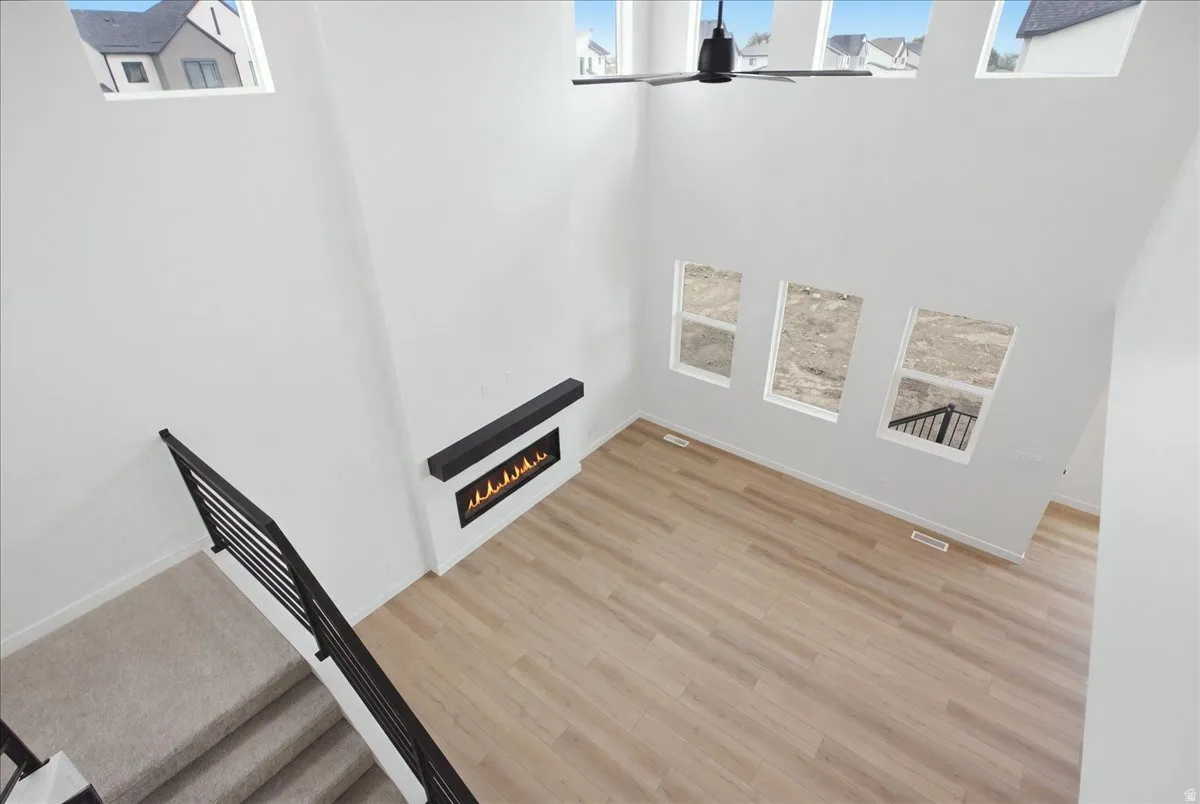 Vaulted Great Room with Large Windows and Upgraded Ceiling Fan