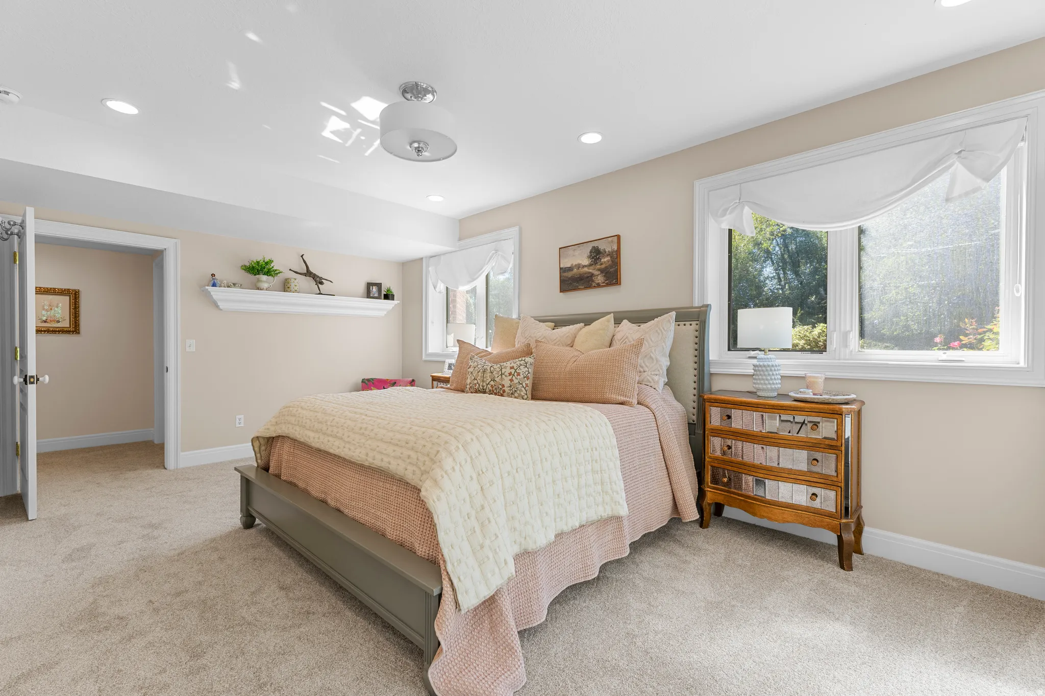 Recessed lighting, ceiling-mounted light fixture, substantial baseboards, window with white trim, and light-toned carpeting