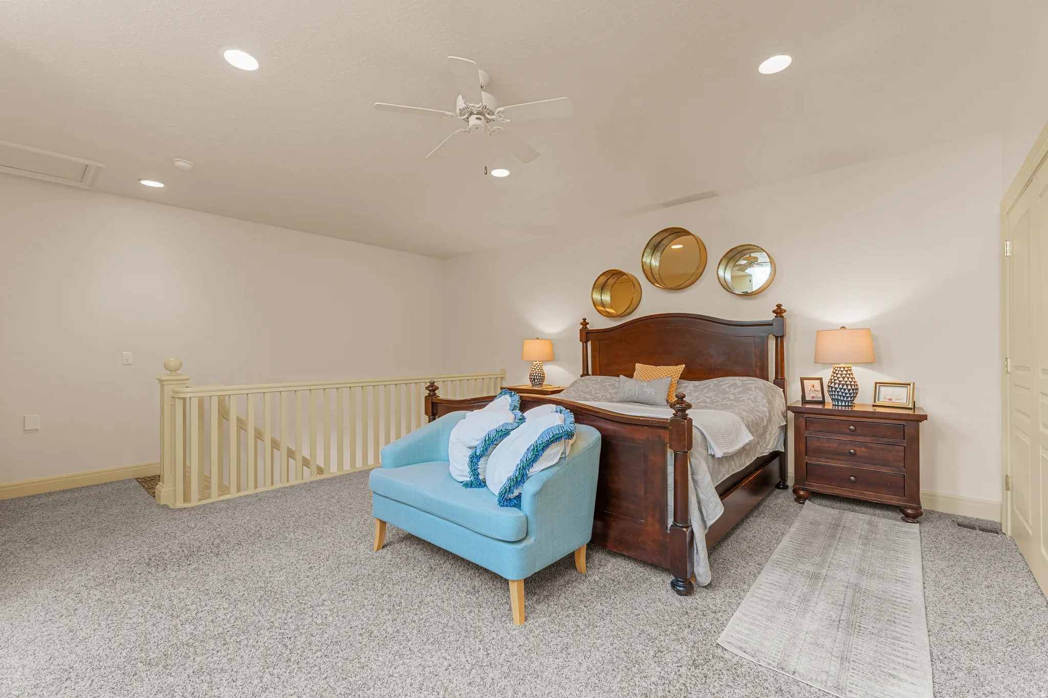 Carpeted bedroom space featuring recessed lighting, a ceiling fan, a wooden bed frame, and wooden nightstands