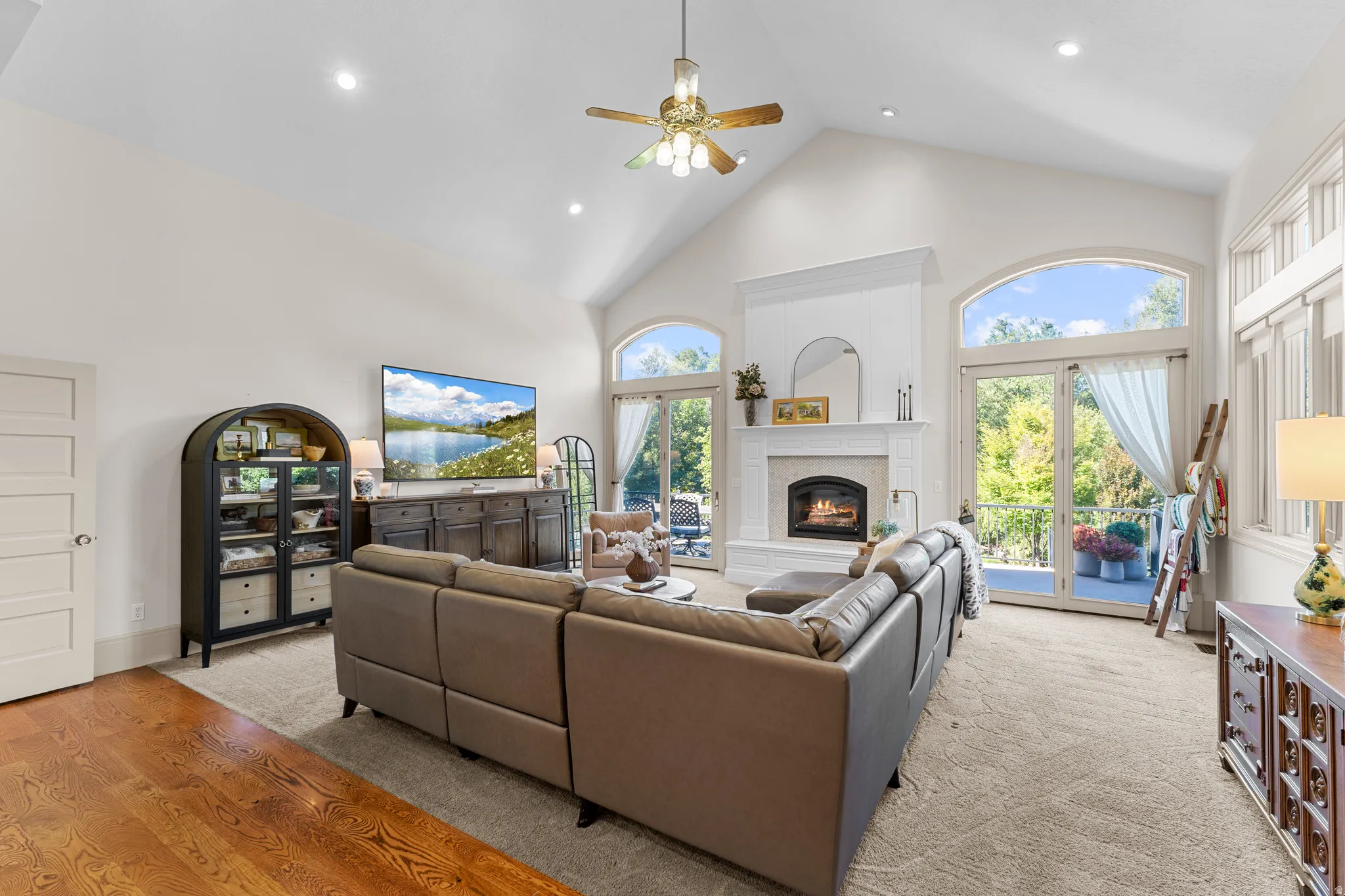 Vaulted ceiling, recessed lighting, fireplace with mantel, French doors, and hardwood flooring