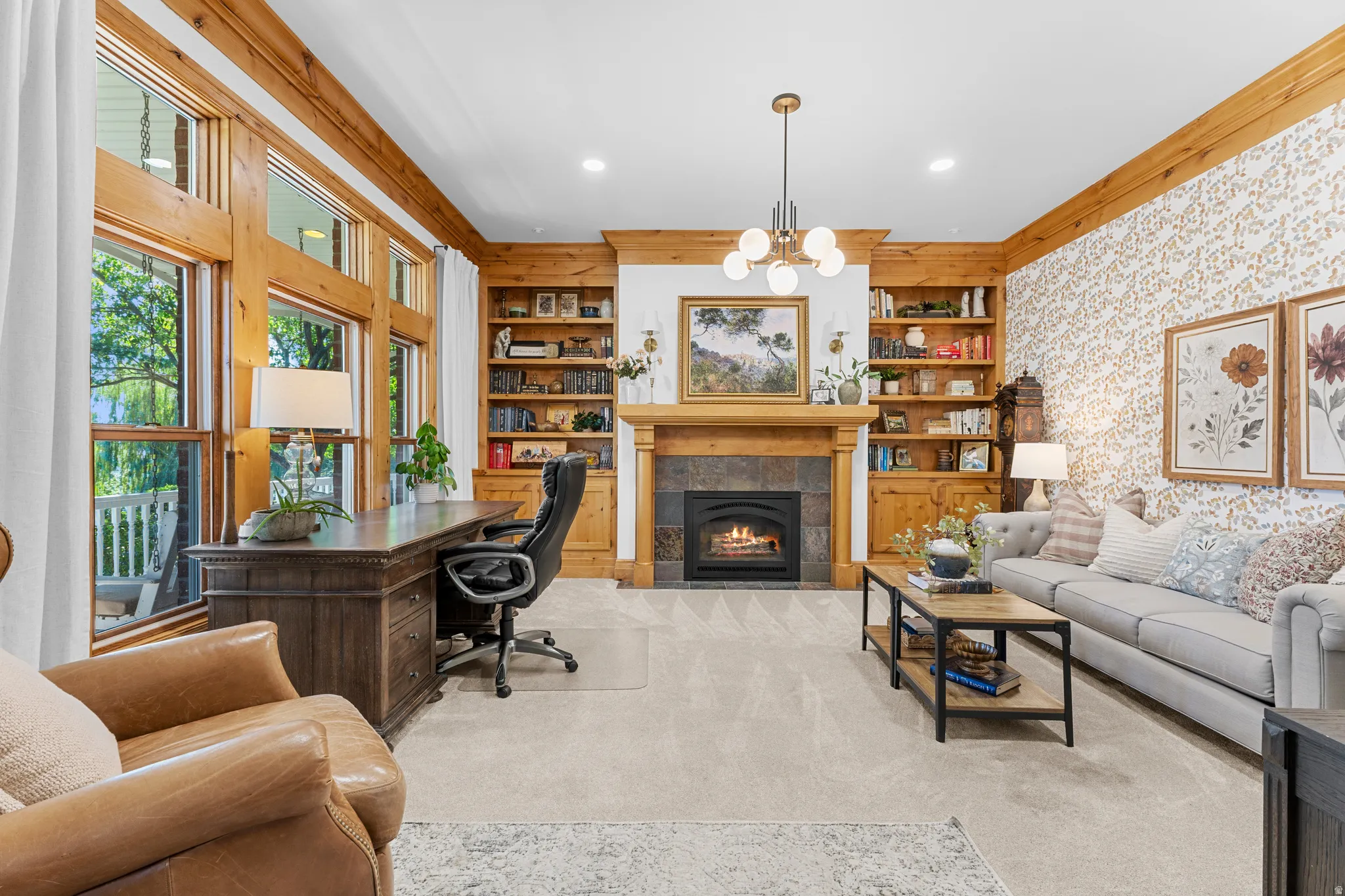 Built-in wood shelving, wood window framing, and a stone-surround fireplace with a wood mantle