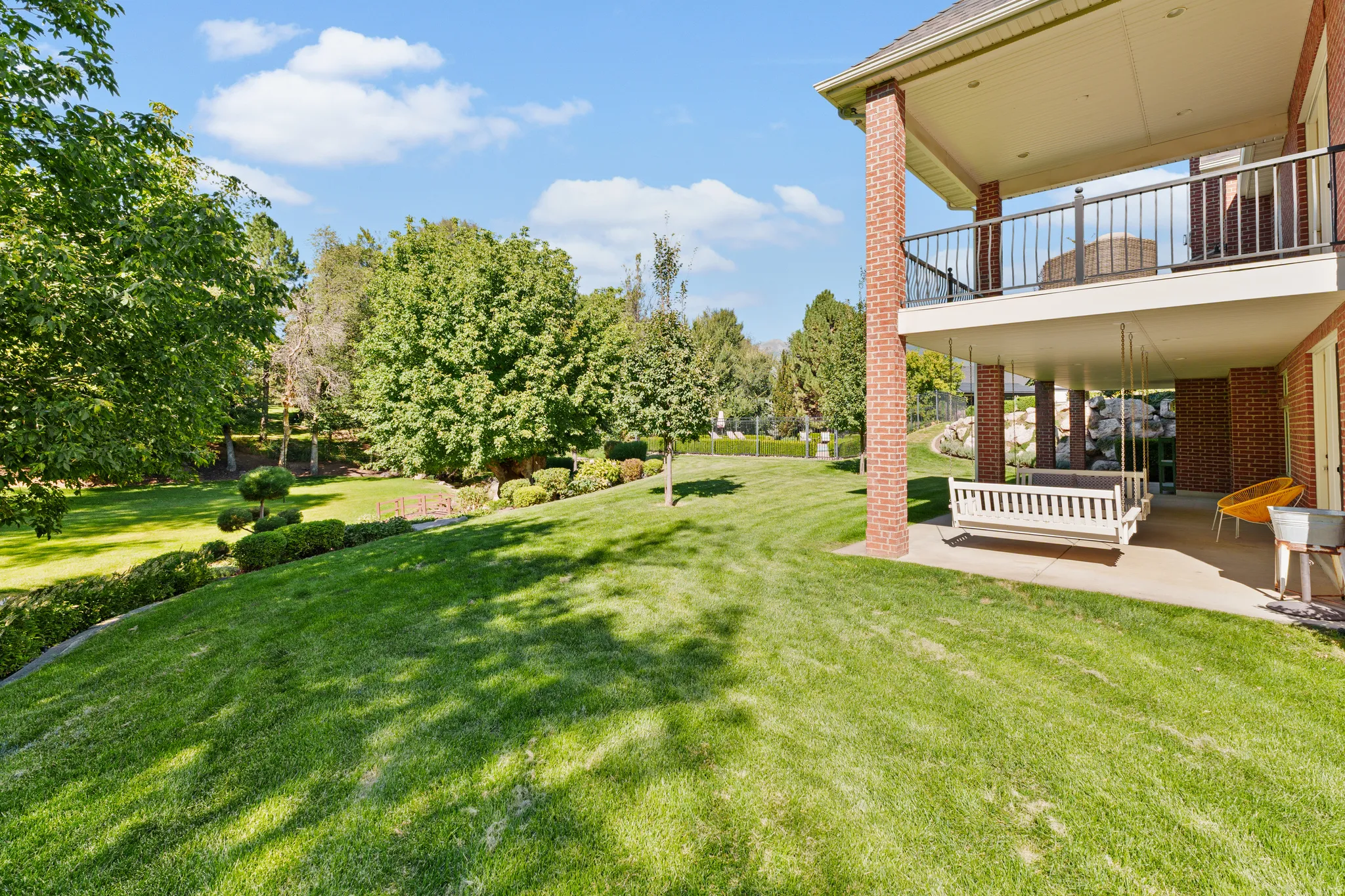 Expansive lawn with mature trees and landscaped shrubbery