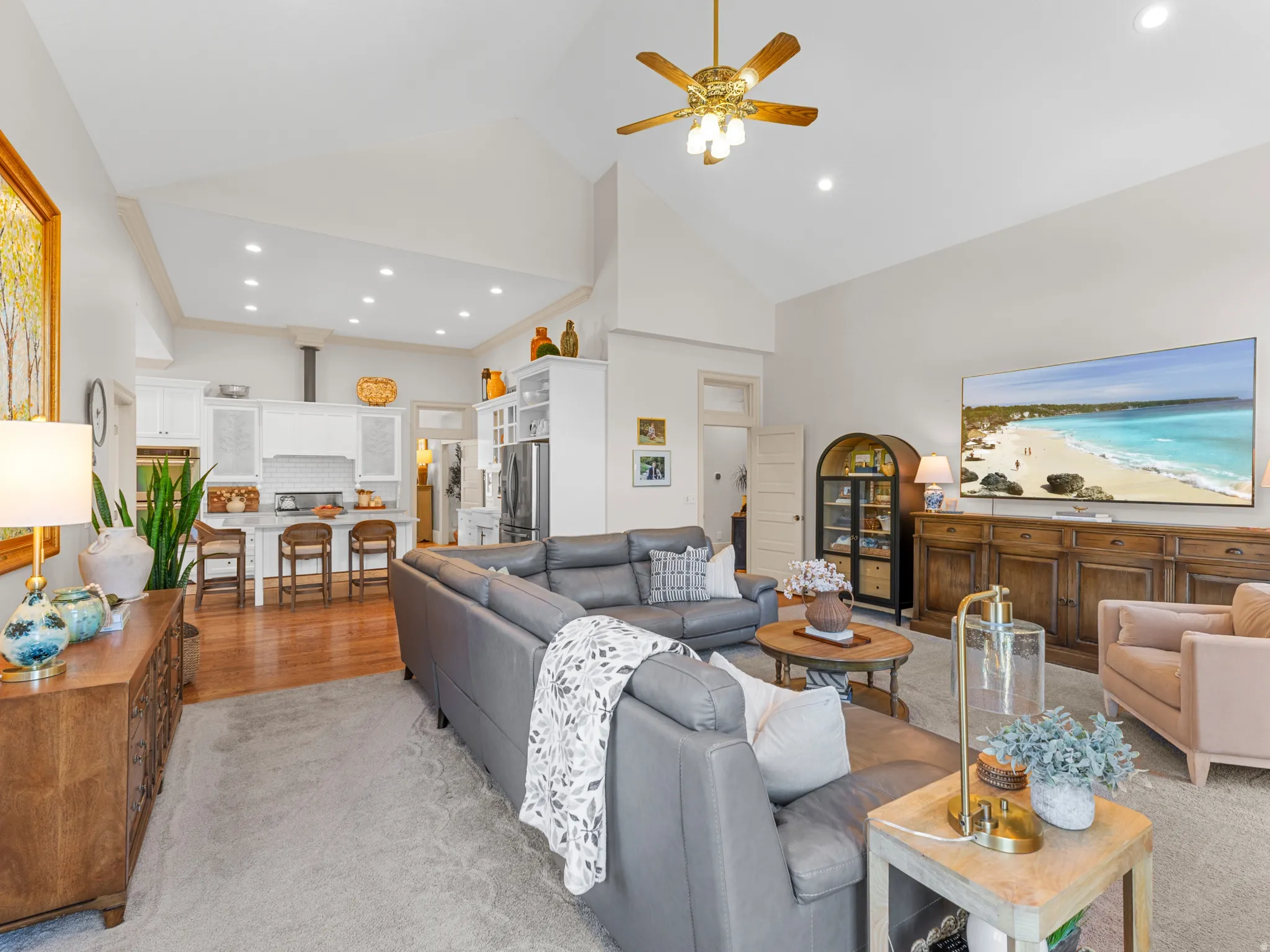 Vaulted ceiling with recessed lighting and a ceiling fan
