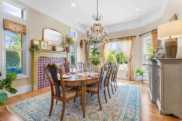 Hardwood flooring, decorative chandelier, recessed lighting, fireplace with tile surround, built-in display shelving
