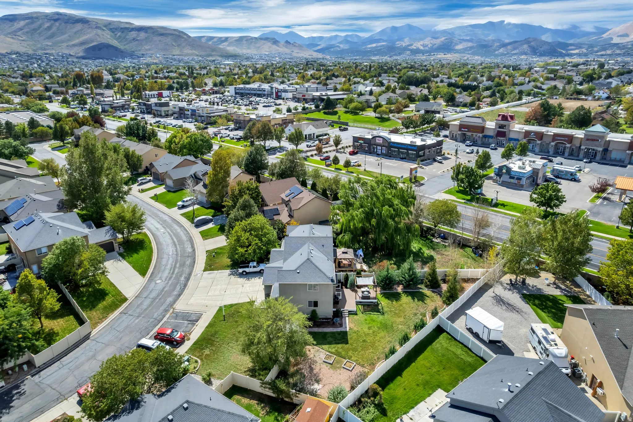 Residential neighborhood with established landscaping and mountain backdrop